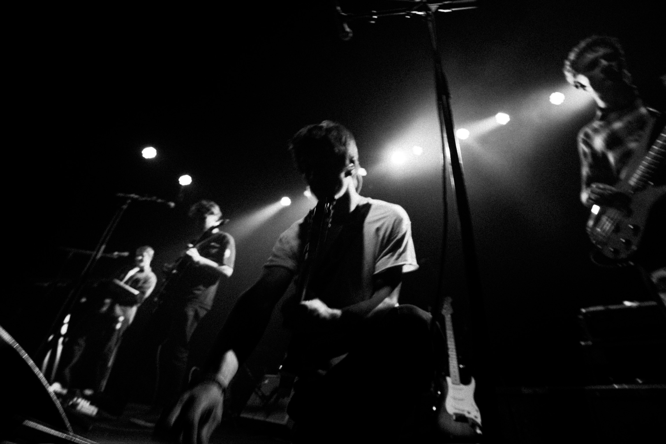 Squash performing live under spotlights at Fox Theatre Boulder