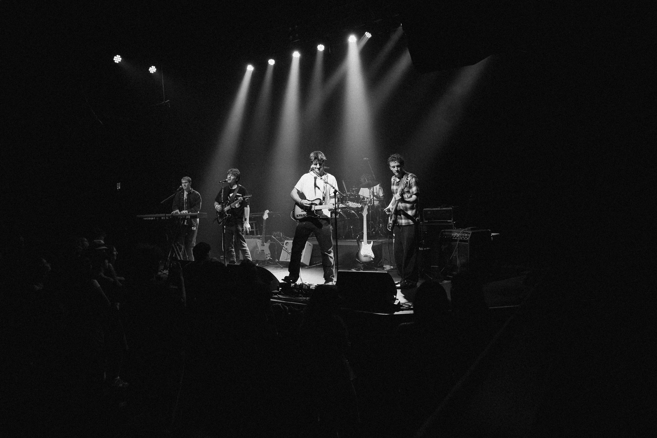 Squash members illuminated by blue and red stage lights at Fox Theatre Boulder