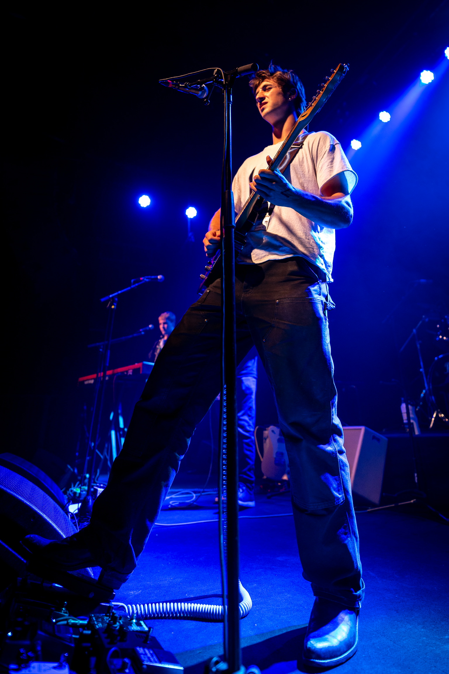 Color photo of Squash performing with atmospheric lighting at Fox Theatre Boulder