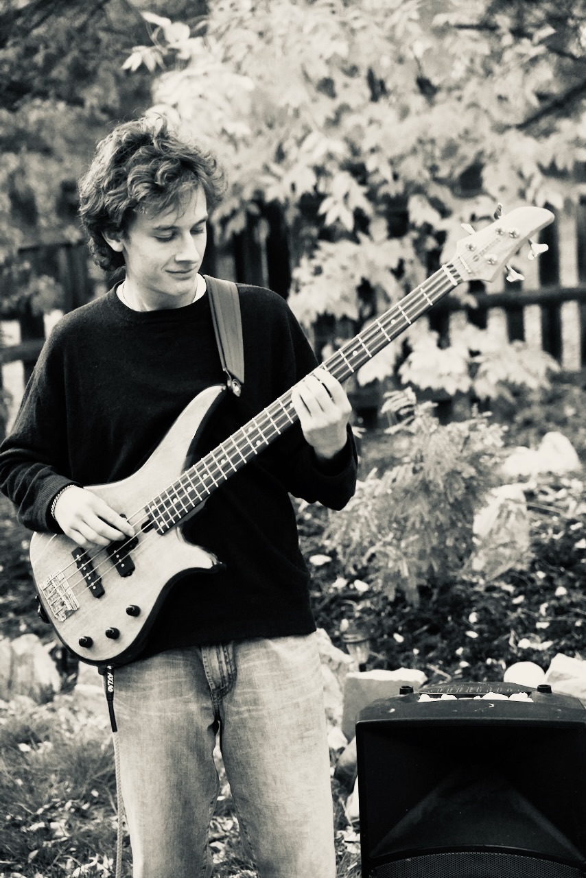 Black and white portrait of David from Squash performing guitar and vocals on stage