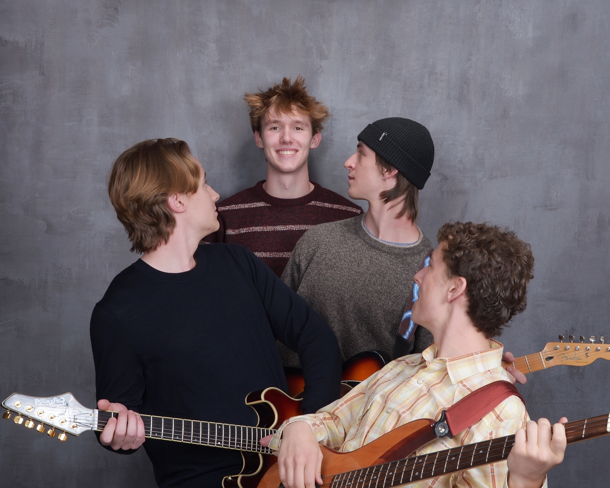 Band photo shoot for Squash featuring members posing indoors with vintage decor